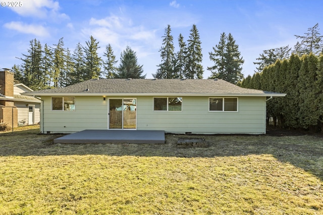 back of house with a lawn