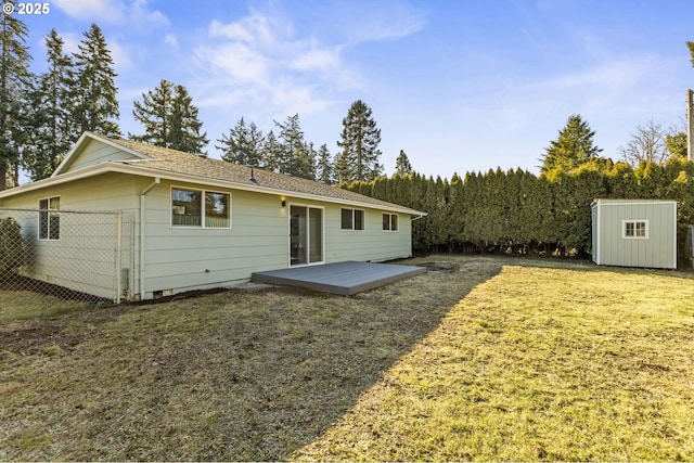 back of property featuring a storage shed and a yard