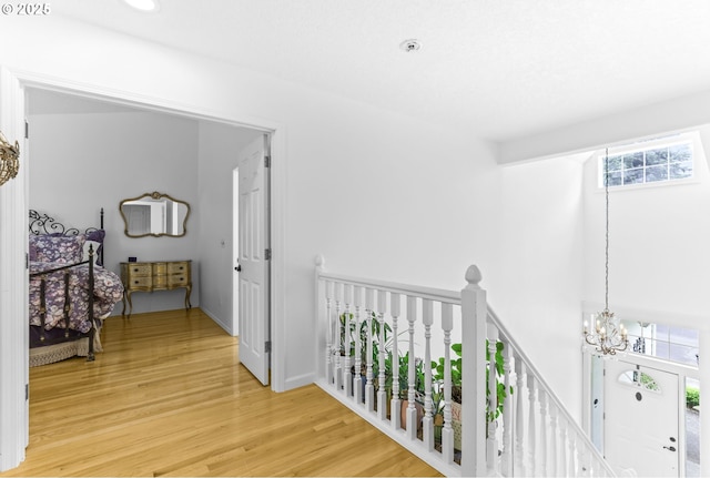 16800 NW Paddington Dr, Beaverton, OR 97006 - hallway featuring an upstairs landing, a chandelier, light wood finished floors, and recessed lighting