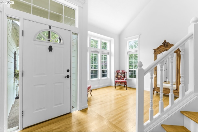 16800 NW Paddington Dr, Beaverton, OR 97006 - entryway with light wood finished floors, stairway, and high vaulted ceiling