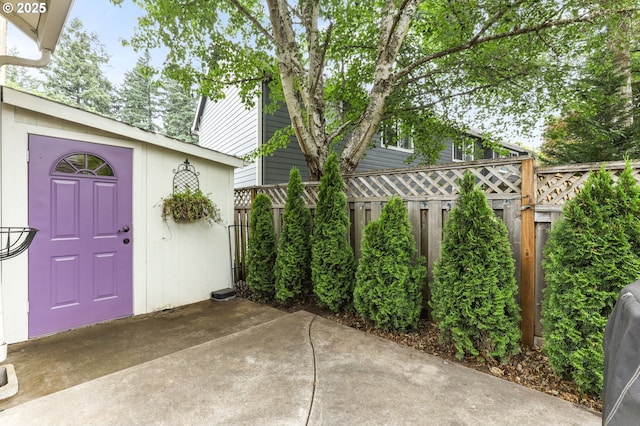 16800 NW Paddington Dr, Beaverton, OR 97006 - fenced backyard with a patio and an outbuilding
