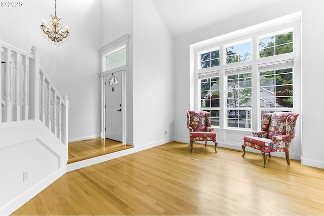 16800 NW Paddington Dr, Beaverton, OR 97006 - entrance foyer featuring stairway, high vaulted ceiling, a chandelier, and light wood-type flooring