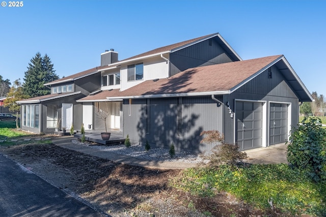 rear view of house with a garage