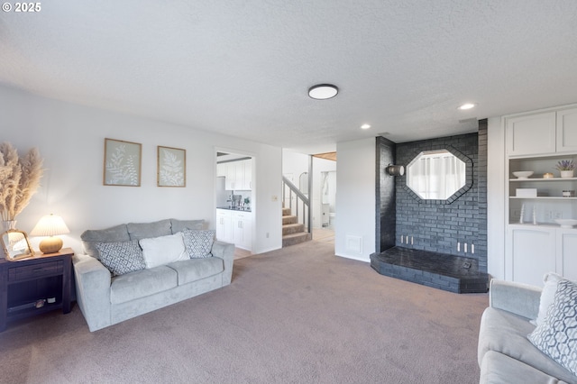 carpeted living room featuring built in features and a textured ceiling