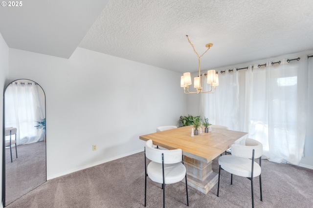 dining room featuring a notable chandelier, a textured ceiling, and carpet