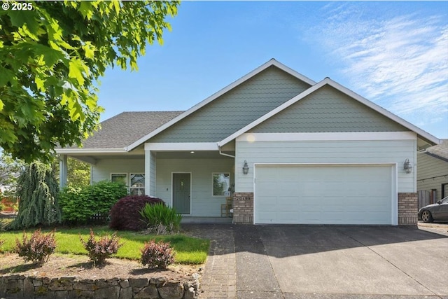 craftsman-style home with brick siding, an attached garage, and concrete driveway