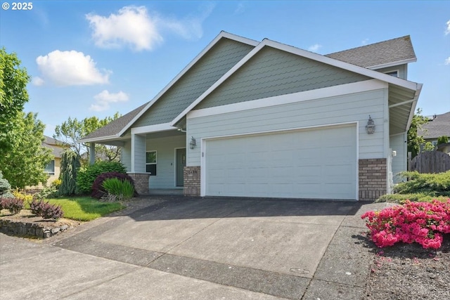 craftsman house featuring an attached garage, concrete driveway, and brick siding