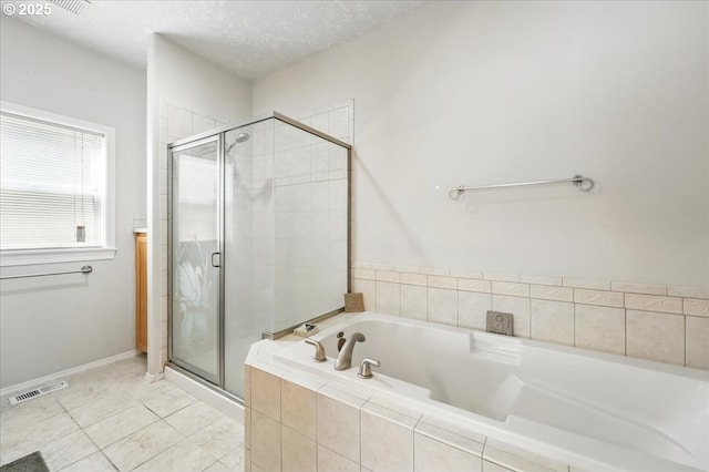 full bath featuring a garden tub, a stall shower, and tile patterned flooring