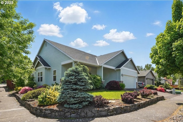 view of home's exterior featuring an attached garage and roof with shingles