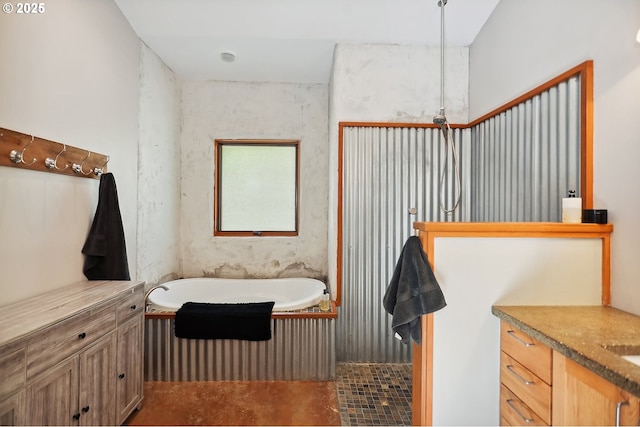 bathroom with a bath, concrete floors, and vanity