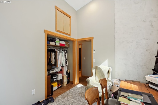 bedroom featuring vaulted ceiling, a closet, and a desk