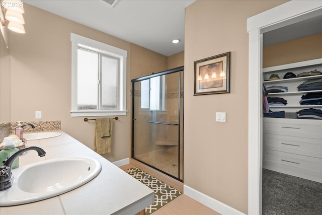 2336 Heather Way, Forest Grove, OR 97116 - bathroom with a stall shower, a walk in closet, double vanity, recessed lighting, and baseboards