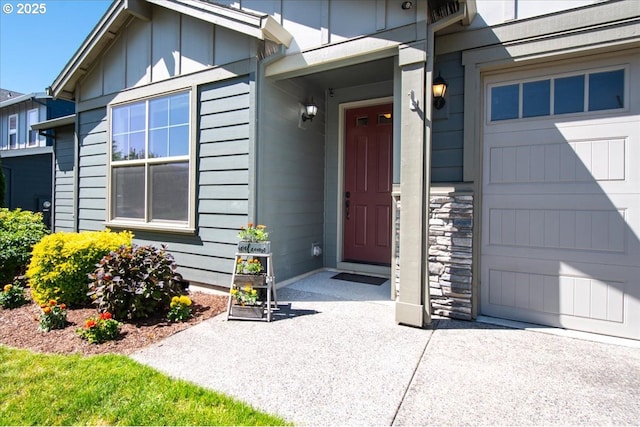 2336 Heather Way, Forest Grove, OR 97116 - doorway to property with board and batten siding, an attached garage, and stone siding