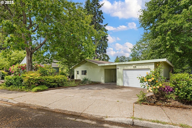 view of front of home with a garage, driveway, and a carport