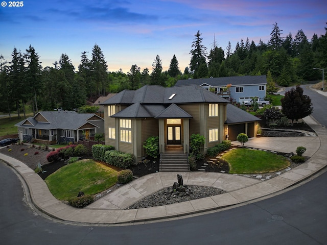 1155 Holly Ave, Cottage Grove, OR 97424 - view of front of house with french doors, curved driveway, a front yard, and a garage