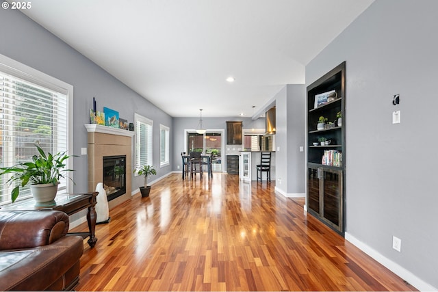 1155 Holly Ave, Cottage Grove, OR 97424 - living room featuring light wood-type flooring, plenty of natural light, a tile fireplace, and recessed lighting