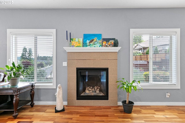 1155 Holly Ave, Cottage Grove, OR 97424 - living area with wood finished floors, healthy amount of natural light, and a fireplace