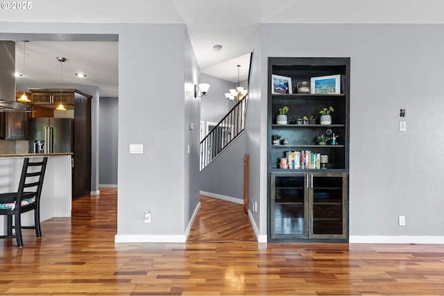 1155 Holly Ave, Cottage Grove, OR 97424 - unfurnished dining area featuring beverage cooler, light wood-style flooring, stairway, and a chandelier