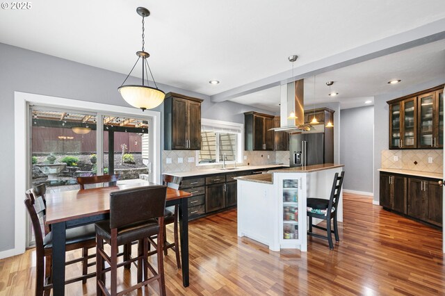 1155 Holly Ave, Cottage Grove, OR 97424 - kitchen featuring island exhaust hood, dark brown cabinetry, wood finished floors, high quality fridge, and recessed lighting