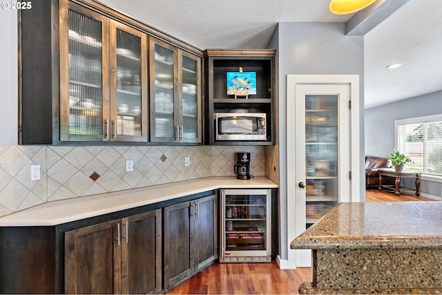 1155 Holly Ave, Cottage Grove, OR 97424 - bar area with beverage cooler, stainless steel microwave, backsplash, and light wood finished floors