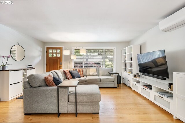 living area with an AC wall unit and light wood-type flooring