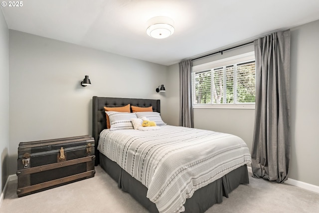 bedroom featuring carpet and baseboards