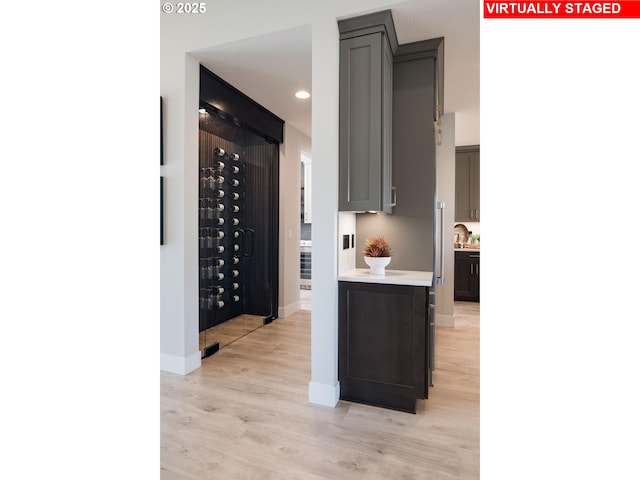 wine area featuring light wood-style floors, recessed lighting, and baseboards