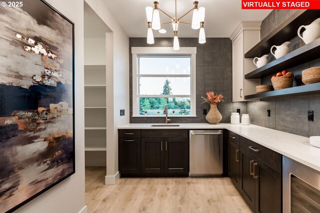 interior space with beverage cooler, dishwasher, light countertops, open shelves, and a sink