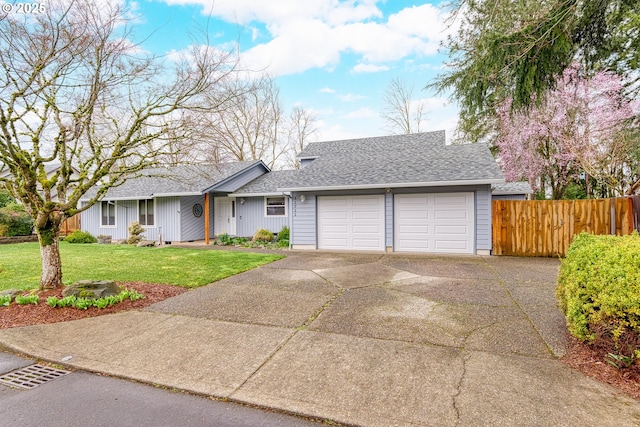 single story home with fence, an attached garage, a shingled roof, a front lawn, and concrete driveway