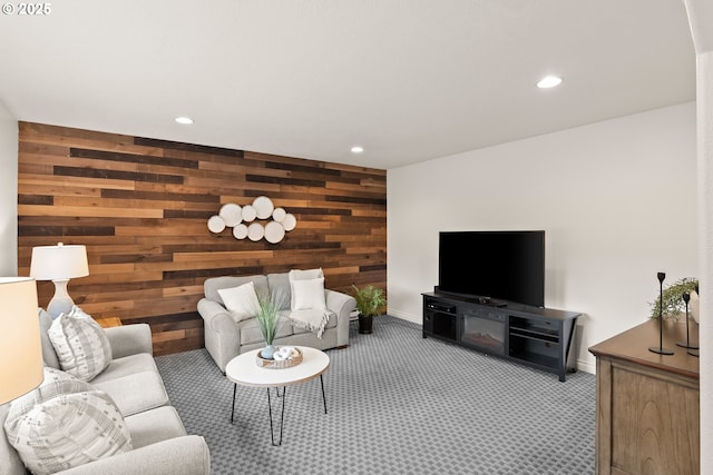 living area featuring wooden walls, recessed lighting, and light colored carpet