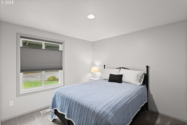 bedroom with visible vents, baseboards, and carpet