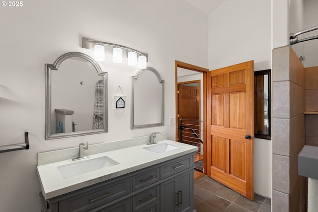 bathroom featuring tile patterned floors, double vanity, and a sink