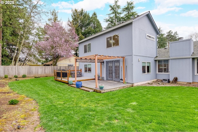 back of house featuring a wooden deck, a pergola, a yard, and fence