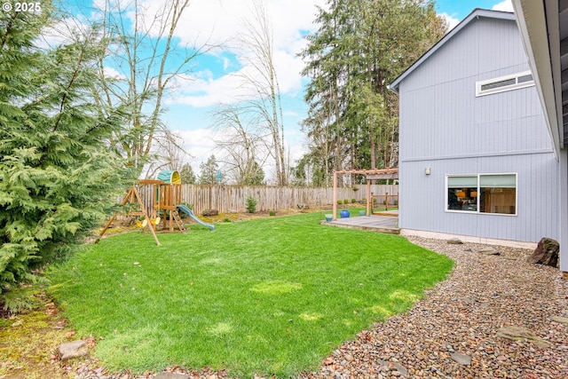 view of yard with a playground and fence