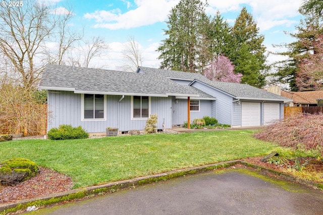 ranch-style home featuring a front yard, roof with shingles, and an attached garage