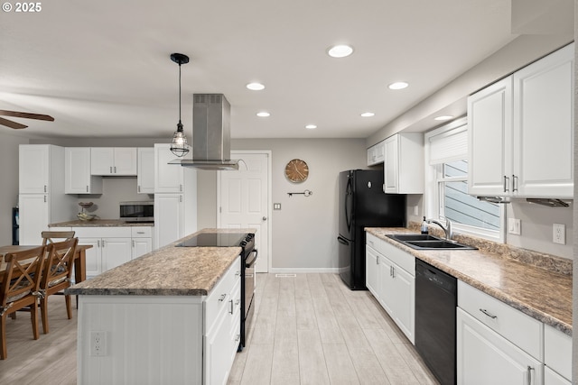 kitchen with light wood finished floors, a kitchen island, a sink, black appliances, and exhaust hood