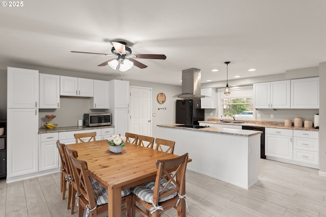 dining area with a ceiling fan, recessed lighting, and wood tiled floor