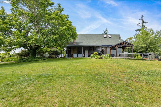 596 Sable Dr, Roseburg, OR 97470 - back of house featuring a lawn, a chimney, a gazebo, and central AC unit