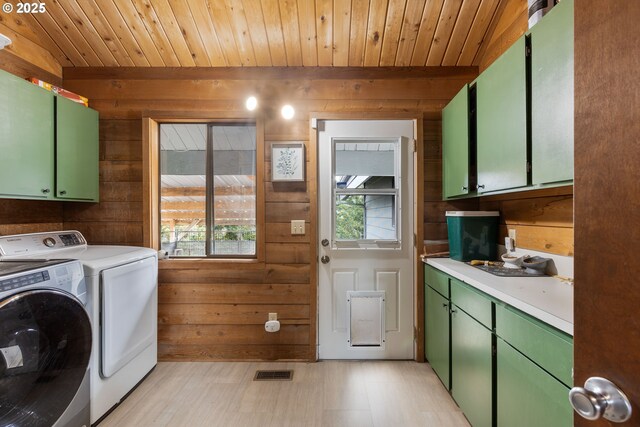 596 Sable Dr, Roseburg, OR 97470 - laundry room featuring wooden walls, cabinet space, washer and clothes dryer, wood ceiling, and light floors