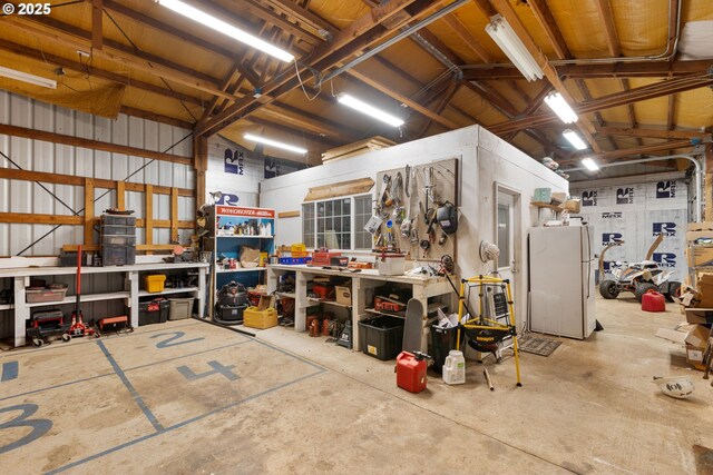 596 Sable Dr, Roseburg, OR 97470 - garage featuring a workshop area and freestanding refrigerator