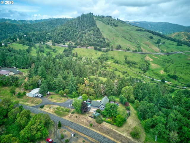 596 Sable Dr, Roseburg, OR 97470 - drone / aerial view of a heavily wooded area and a mountainous background