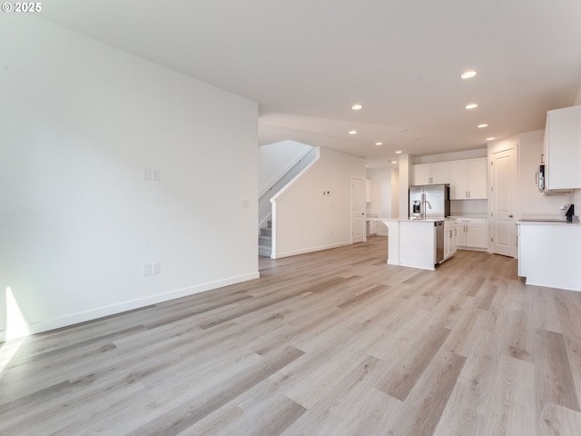 532 SW 23rd St, Battle Ground, WA 98604 - unfurnished living room featuring recessed lighting, light wood-type flooring, stairway, and baseboards