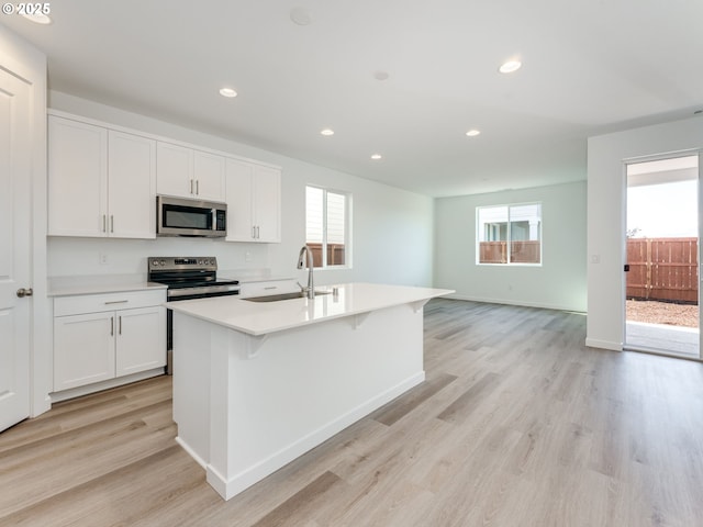 532 SW 23rd St, Battle Ground, WA 98604 - kitchen featuring appliances with stainless steel finishes, a sink, plenty of natural light, light wood finished floors, and recessed lighting