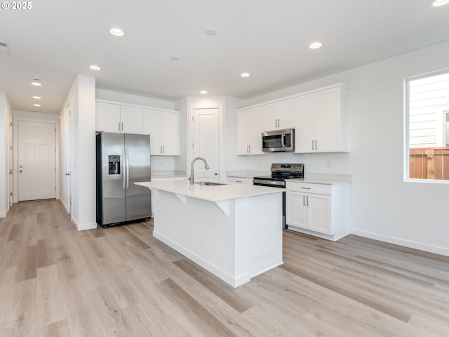 532 SW 23rd St, Battle Ground, WA 98604 - kitchen featuring appliances with stainless steel finishes, a sink, light wood-type flooring, light countertops, and white cabinets