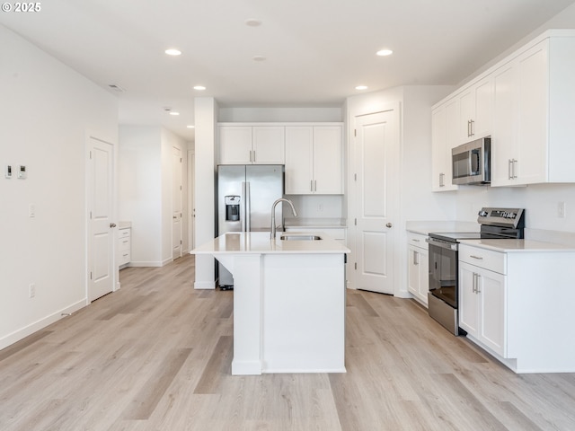 532 SW 23rd St, Battle Ground, WA 98604 - kitchen featuring appliances with stainless steel finishes, a sink, recessed lighting, light wood-style floors, and white cabinetry