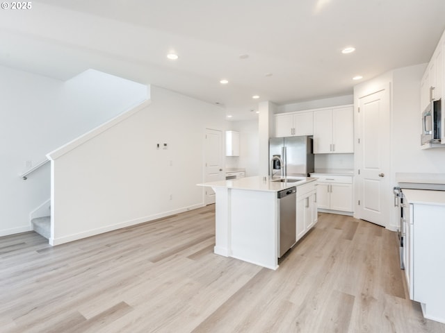 532 SW 23rd St, Battle Ground, WA 98604 - kitchen with appliances with stainless steel finishes, light wood-type flooring, white cabinets, recessed lighting, and an island with sink