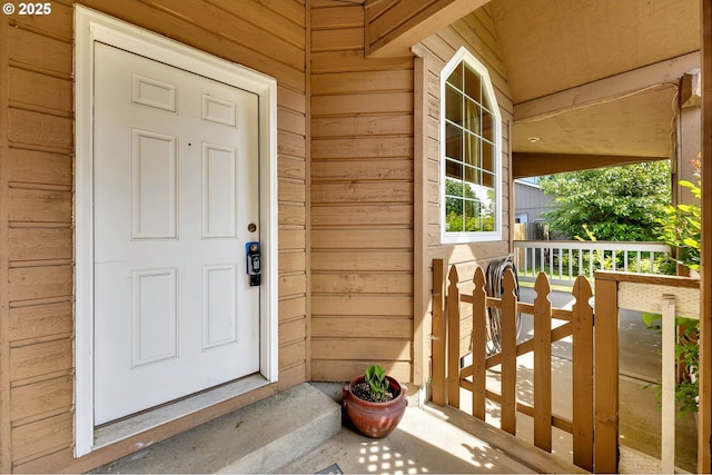 view of exterior entry featuring a porch