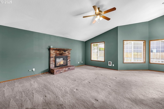 unfurnished living room with carpet floors, ceiling fan, a brick fireplace, baseboards, and lofted ceiling