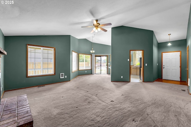 unfurnished living room featuring baseboards, visible vents, ceiling fan, and carpet