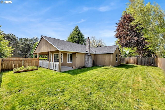 back of house with a patio area, a chimney, a fenced backyard, a lawn, and roof with shingles